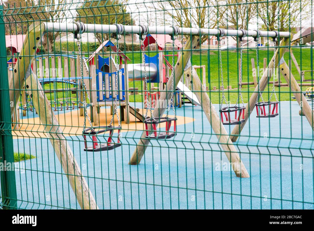 Empty swings at the children`s playground in Maynooth Ireland closed due to Covid-19 pandemic. Stock Photo